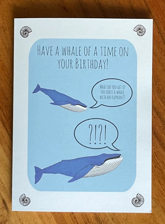 Two whales on a blue greeting card telling a joke.