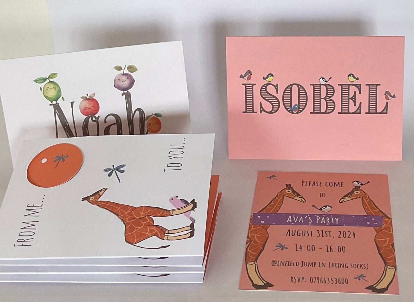 A collection of kid’s personalised greeting cards with animal bird and fruit motifs and giraffes invitations